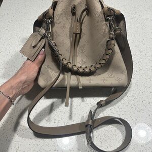 Louis Vuitton Mahina Muria bucket bag in Galet (taupe) perforated calf leather.